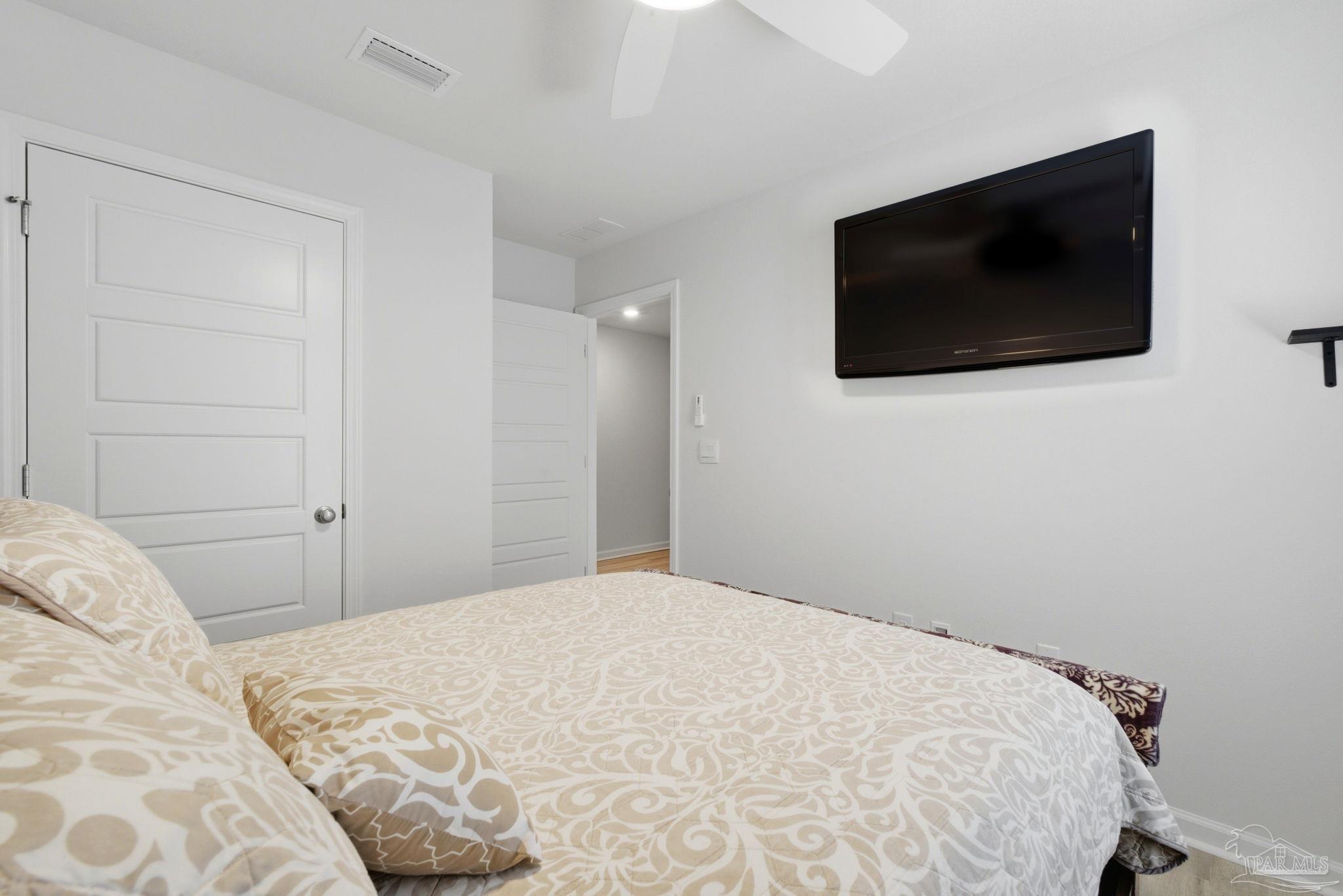 6126 Native Dancer Way Pensacola, FL 32526 - Photo 11 of 40 a bedroom with a flat screen tv and a wall painting