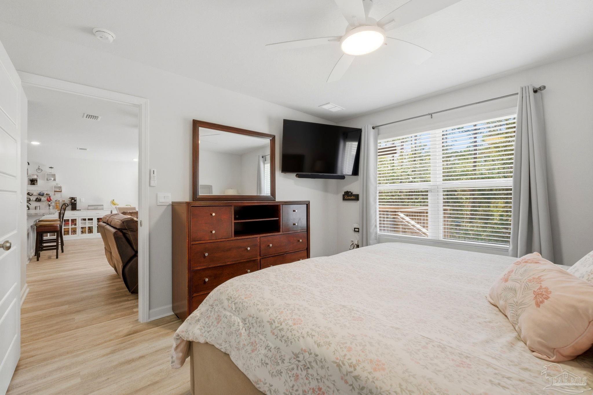6126 Native Dancer Way Pensacola, FL 32526 - Photo 13 of 40 a spacious bedroom with a large bed and a flat tv screen on dresser