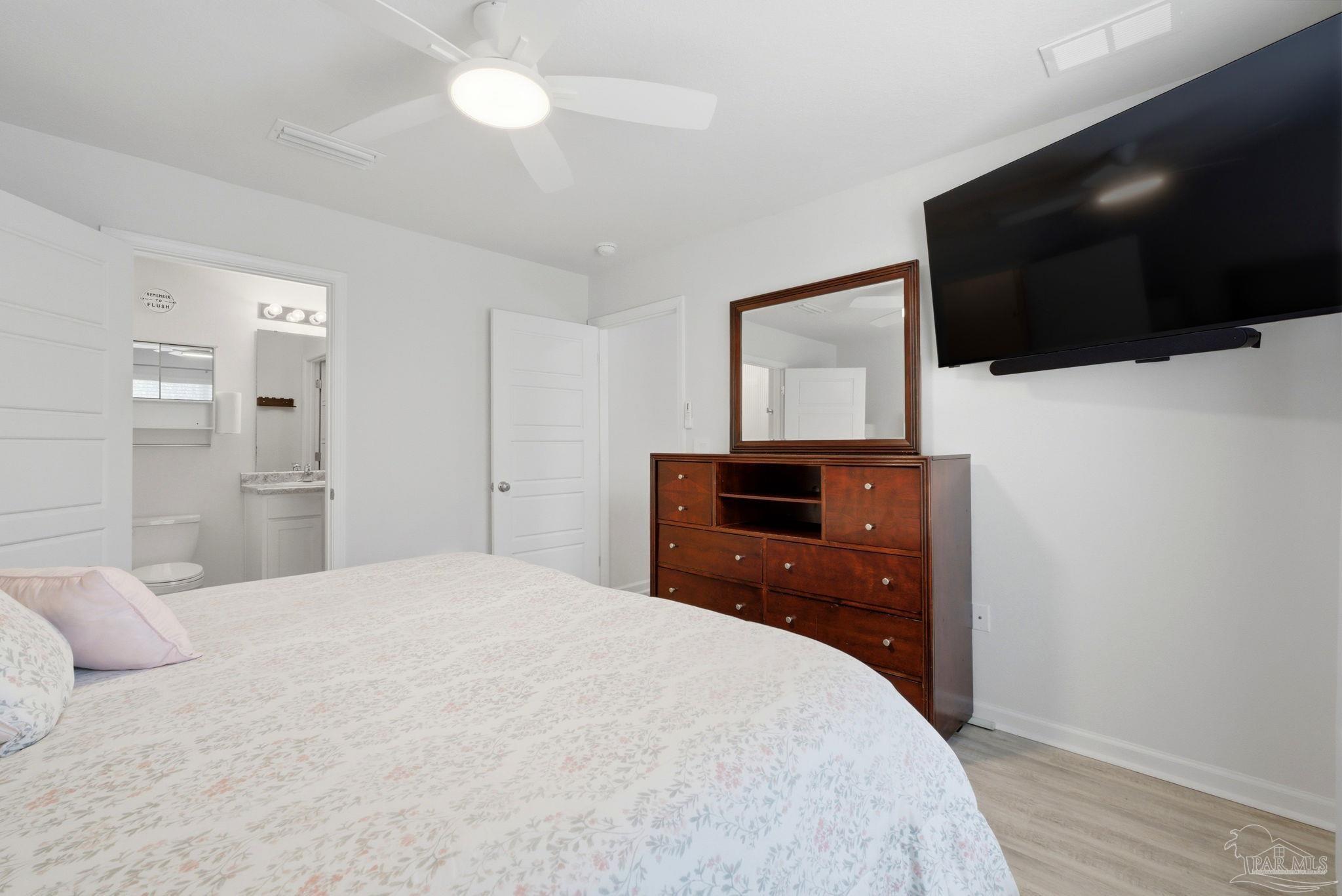 6126 Native Dancer Way Pensacola, FL 32526 - Photo 14 of 40 a bedroom with a bed and a flat screen tv