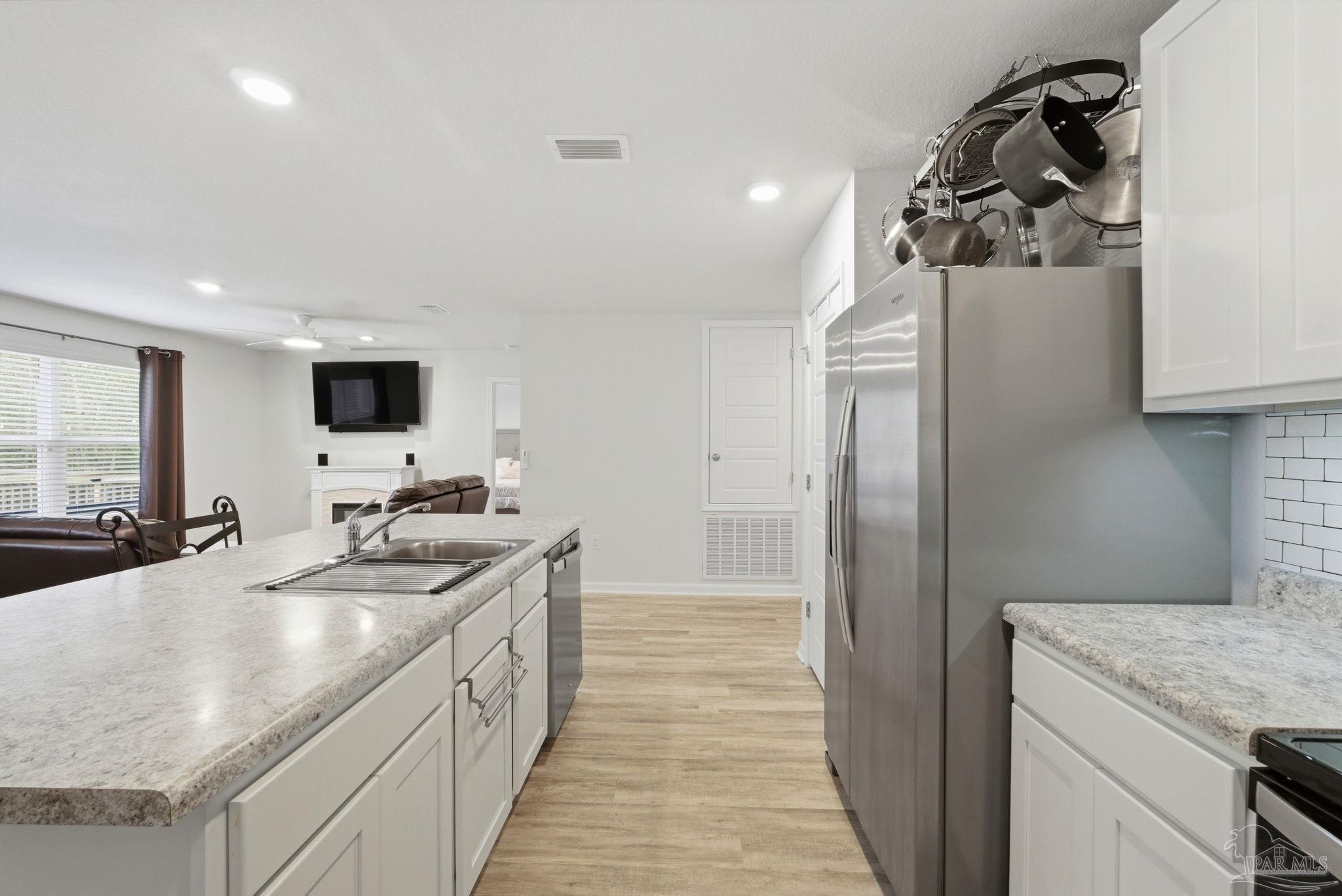 6126 Native Dancer Way Pensacola, FL 32526 - Photo 24 of 40 a kitchen with a sink stove and refrigerator