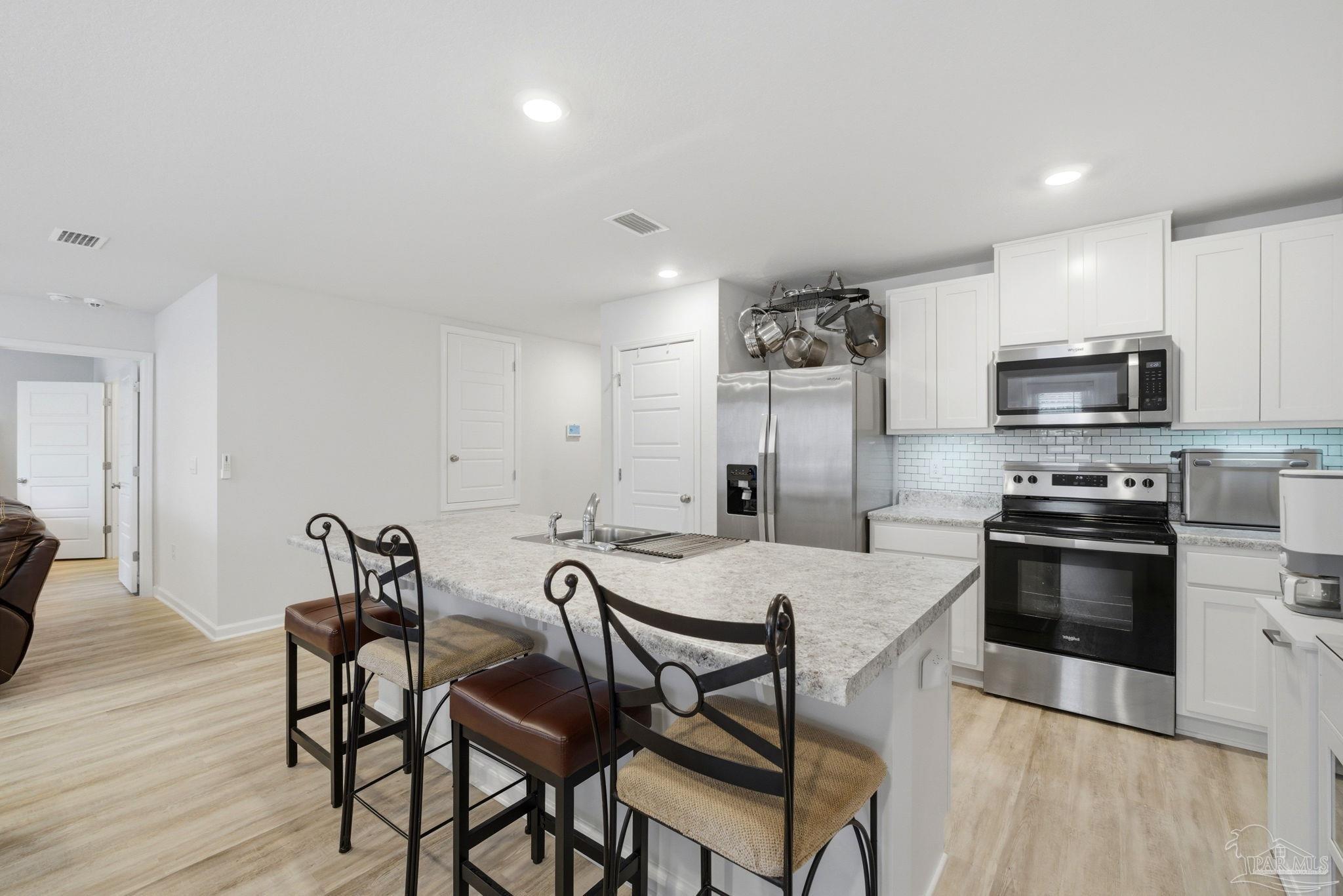 6126 Native Dancer Way Pensacola, FL 32526 - Photo 25 of 40 a view of a dining room with furniture and wooden floor
