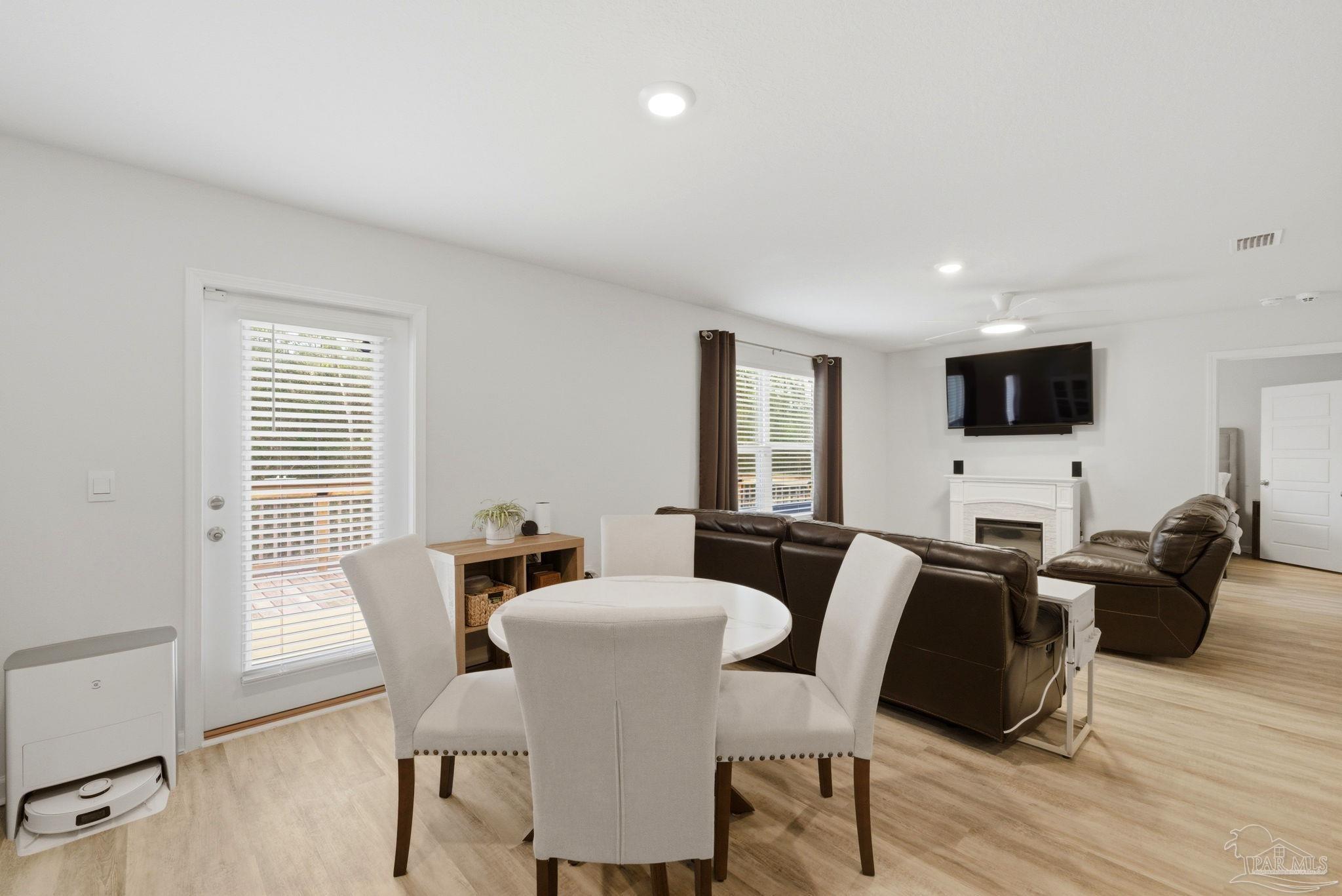 6126 Native Dancer Way Pensacola, FL 32526 - Photo 26 of 40 a view of a dining room with furniture and wooden floor