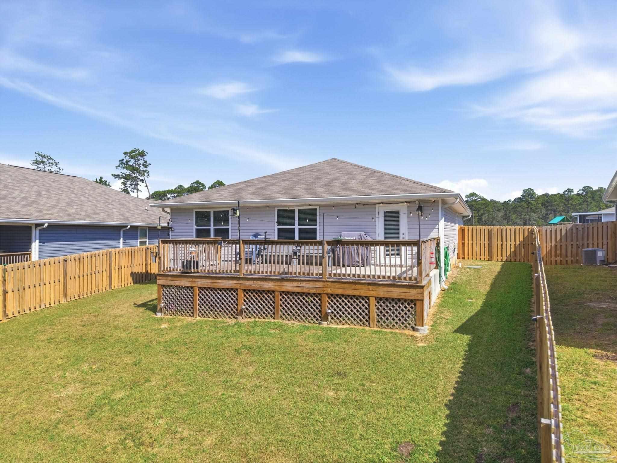 6126 Native Dancer Way Pensacola, FL 32526 - Photo 3 of 40 a front view of a house with a yard table and chairs