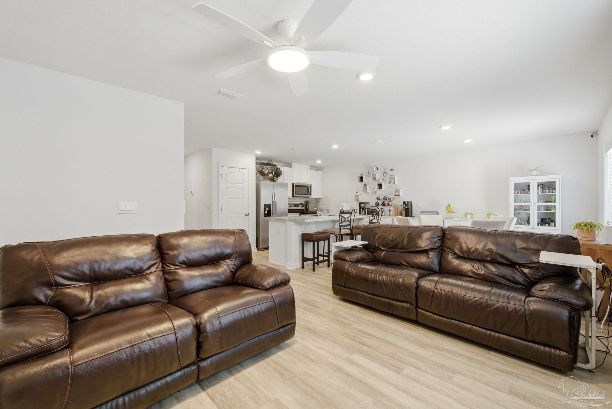 6126 Native Dancer Way Pensacola, FL 32526 - Photo 31 of 40 a living room with furniture a couch and wooden floor