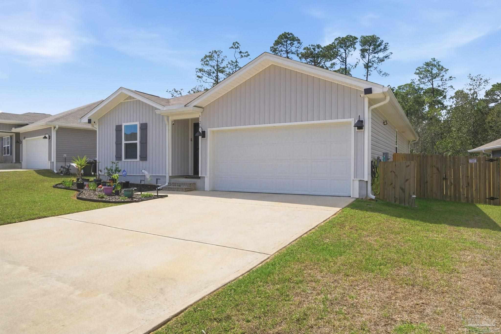 6126 Native Dancer Way Pensacola, FL 32526 - Photo 4 of 40 a front view of a house with a yard and garage