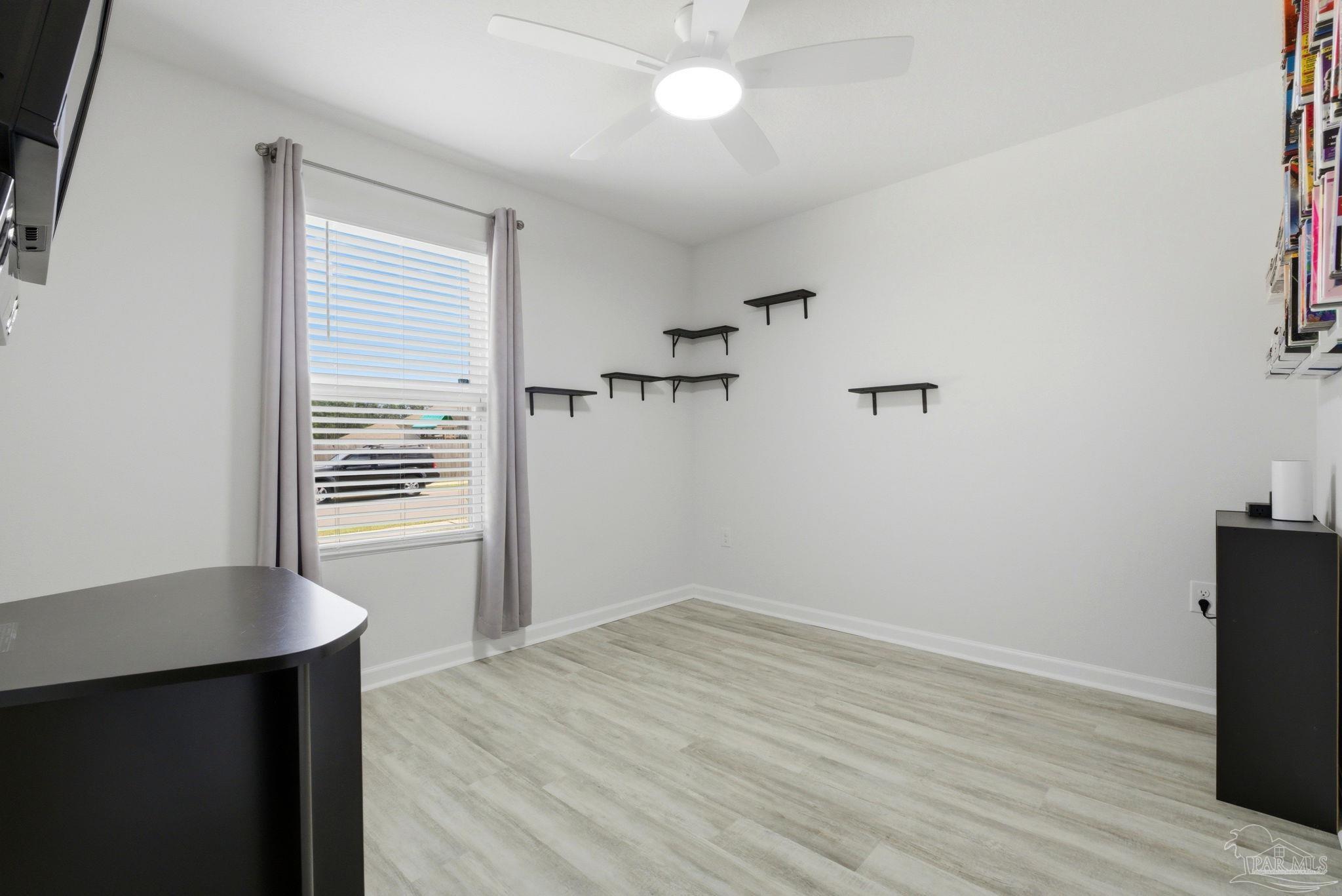 6126 Native Dancer Way Pensacola, FL 32526 - Photo 7 of 40 an empty room with wooden floor and windows