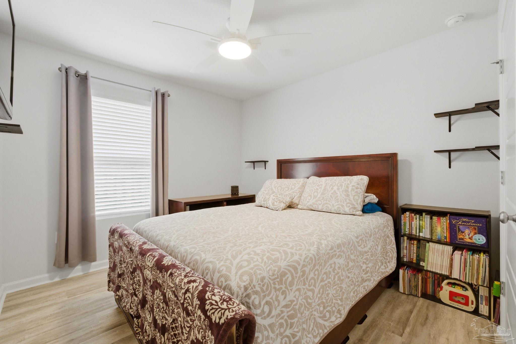 6126 Native Dancer Way Pensacola, FL 32526 - Photo 10 of 40 a bedroom with a bed and a book shelf