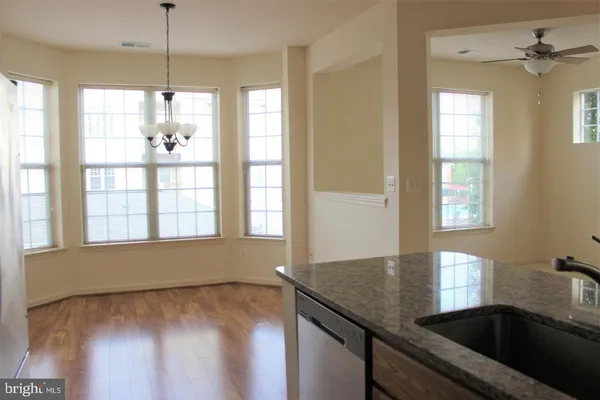a view of a kitchen with a sink and windows