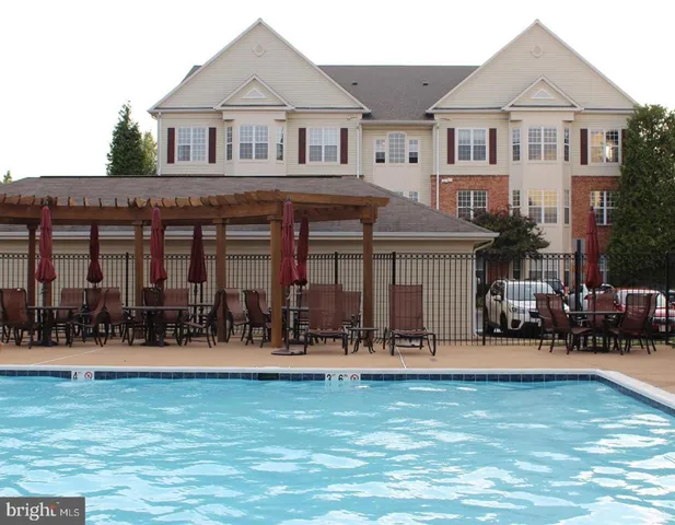 a front view of multiple houses with yard