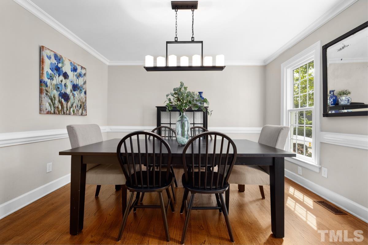8804 Audley Circle Raleigh, NC 27615 - Photo 12 of 54 a view of a dining room with furniture window and wooden floor