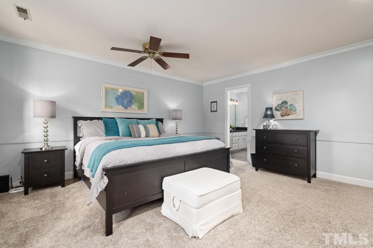 8804 Audley Circle Raleigh, NC 27615 - Photo 18 of 54 a bedroom with a bed and a chandelier