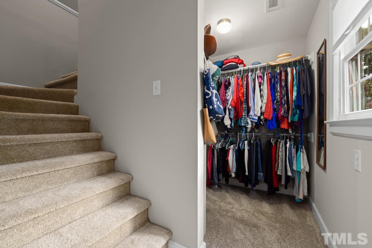 8804 Audley Circle Raleigh, NC 27615 - Photo 23 of 54 a view of walk in closet with clothes and shoes