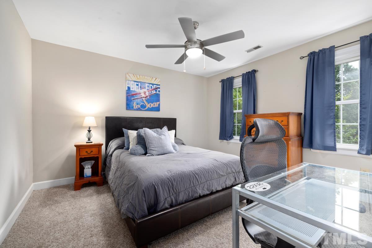 8804 Audley Circle Raleigh, NC 27615 - Photo 28 of 54 a bedroom with a bed and a large window