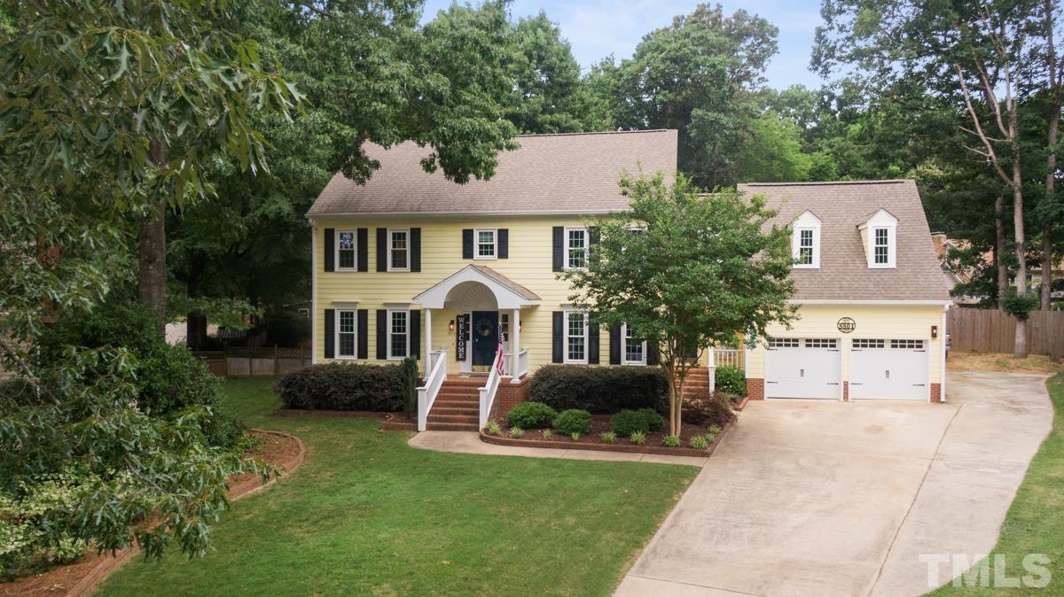 8804 Audley Circle Raleigh, NC 27615 - Photo 49 of 54 a front view of a house with a garden and trees