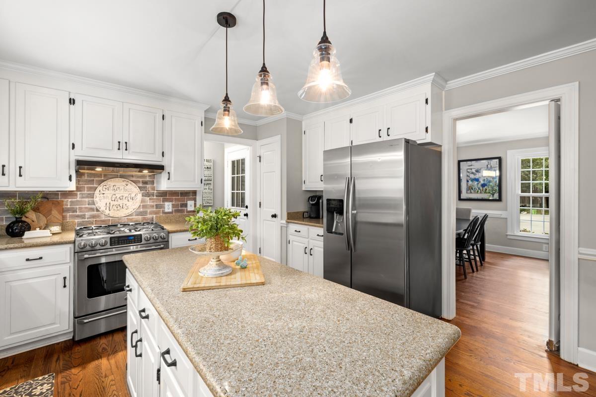 8804 Audley Circle Raleigh, NC 27615 - Photo 6 of 54 a kitchen with stainless steel appliances granite countertop a sink a stove a refrigerator and cabinets