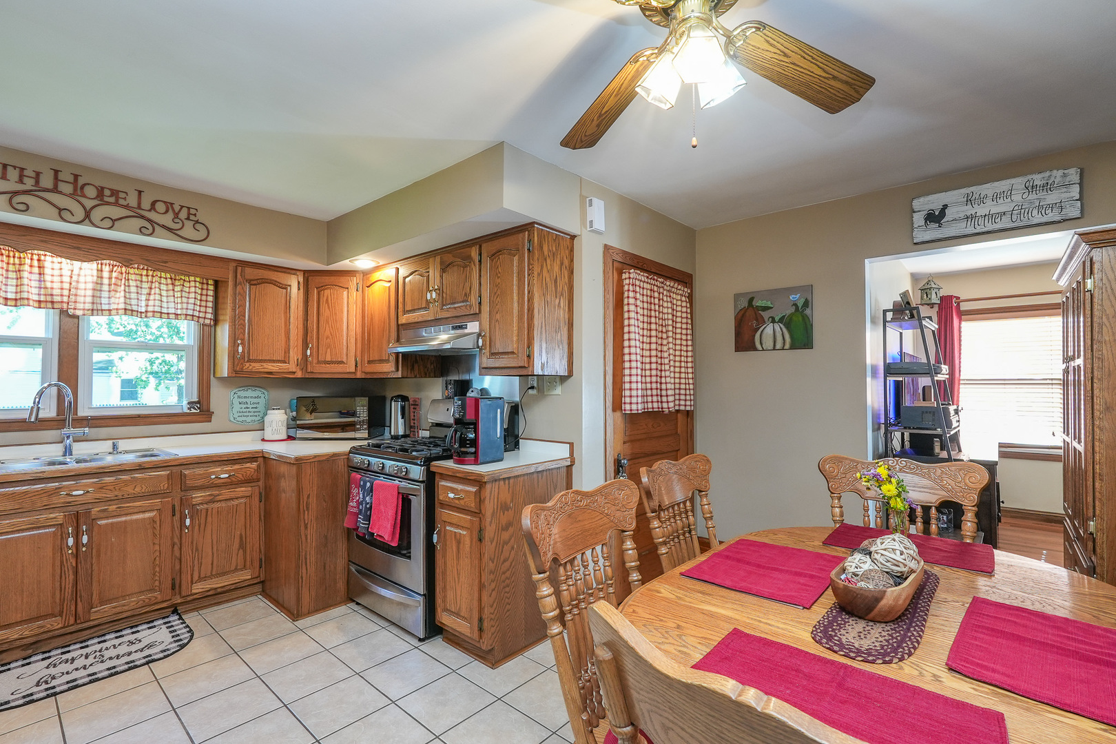244 West 4th Street Manteno, IL 60950 - Photo 13 of 42 a open kitchen with stainless steel appliances kitchen island granite countertop a dining table chairs sink and cabinets