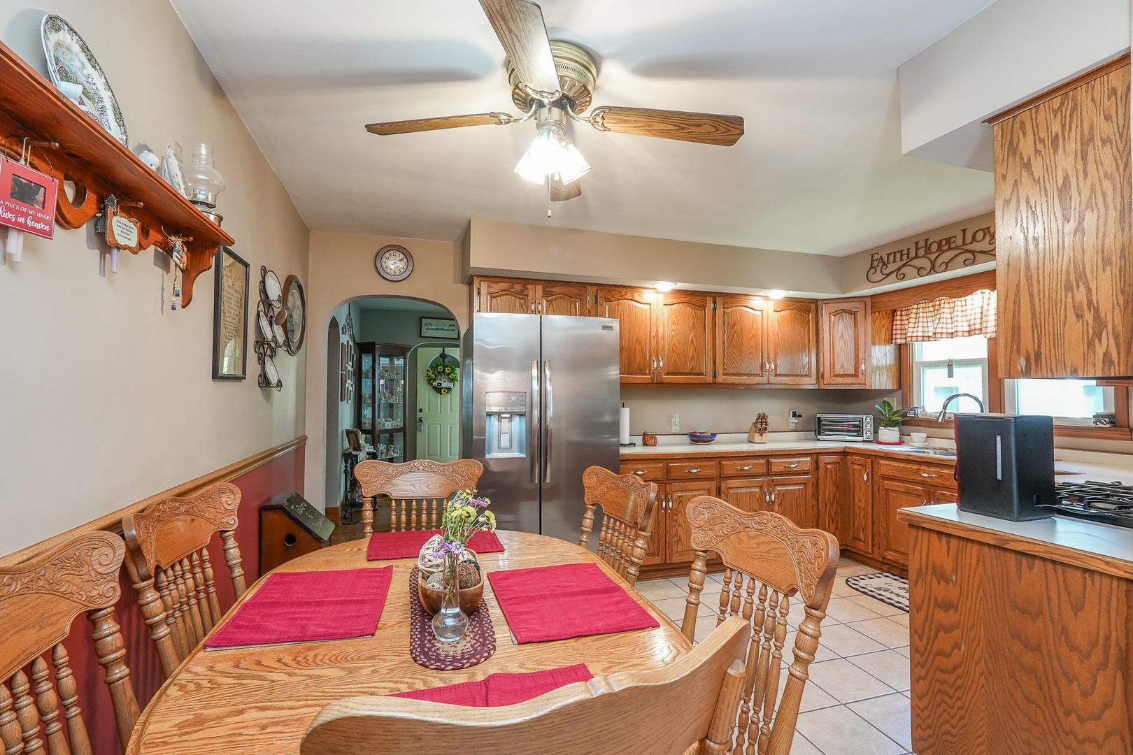 244 West 4th Street Manteno, IL 60950 - Photo 16 of 42 a kitchen with stainless steel appliances kitchen island granite countertop a dining table chairs with wooden floor and chandelier