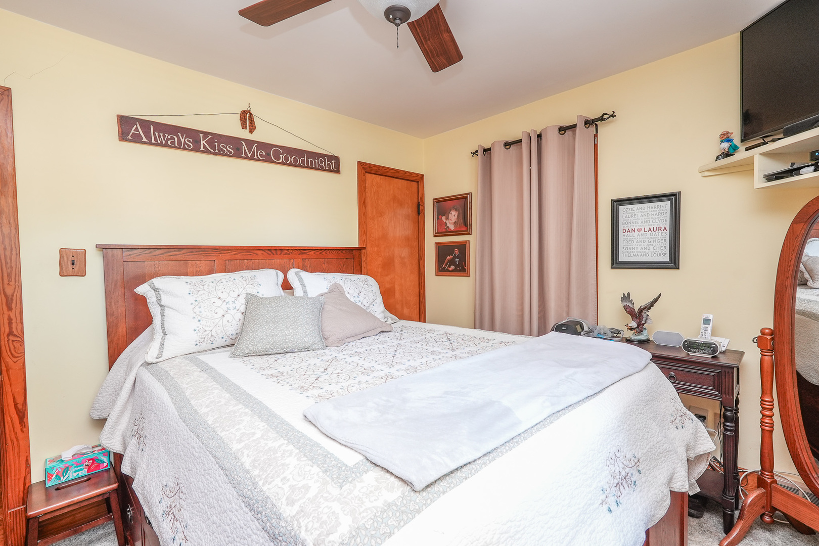 244 West 4th Street Manteno, IL 60950 - Photo 10 of 42 a large bedroom with a bed and a flat tv screen on dresser