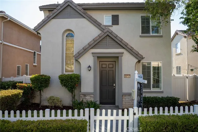 a front view of house with a garden