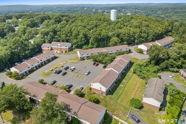 an aerial view of a house with a yard