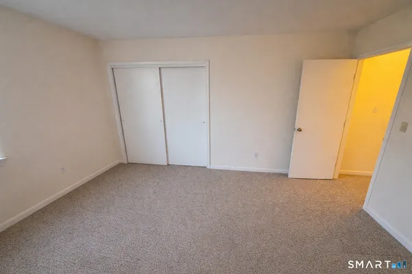 a view of an empty room and a window
