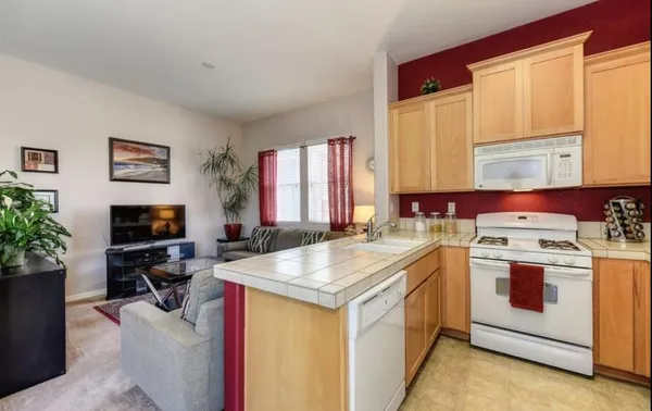 a kitchen that has a sink and a stove in it