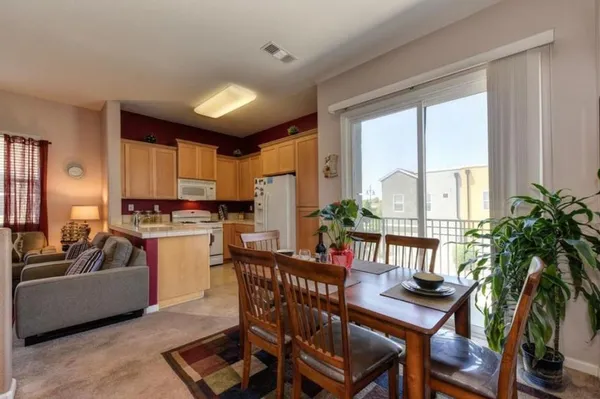 a view of a dining room with furniture window and wooden floor