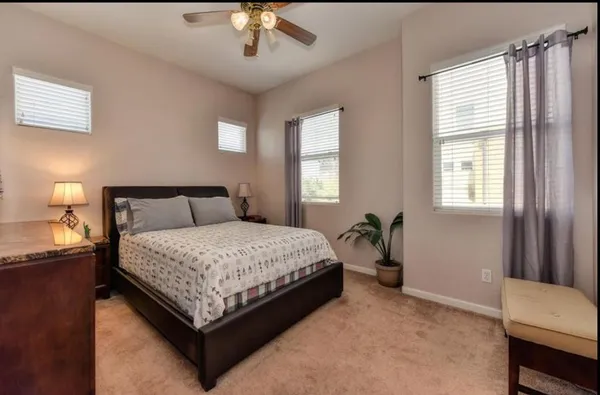 a bedroom with a large bed and a chandelier