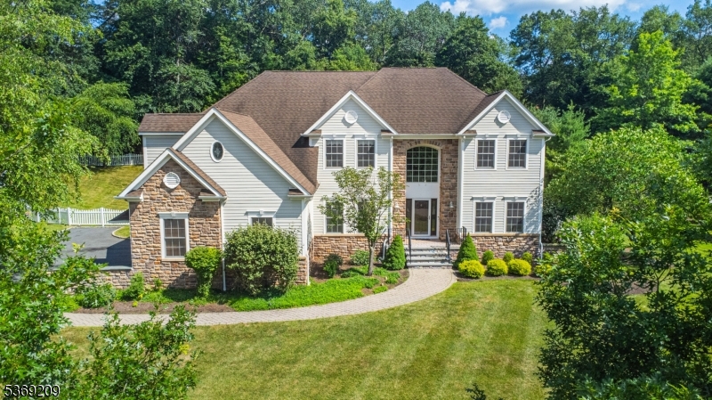 a view of house with garden and tall trees