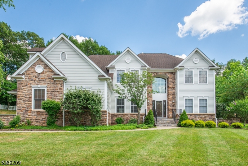 6 Perin Place Succasunna, NJ 07876 - Photo 32 of 39 a front view of a house with a yard and garage