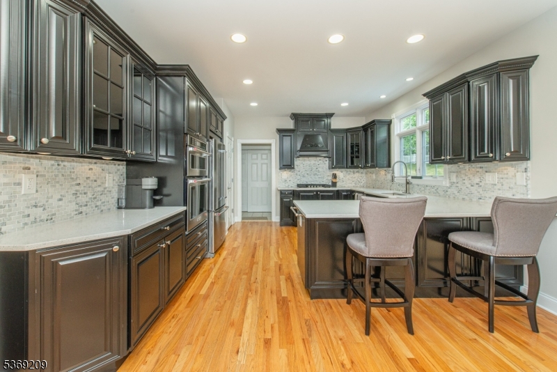 6 Perin Place Succasunna, NJ 07876 - Photo 8 of 39 a kitchen with stainless steel appliances granite countertop a table chairs sink and cabinets