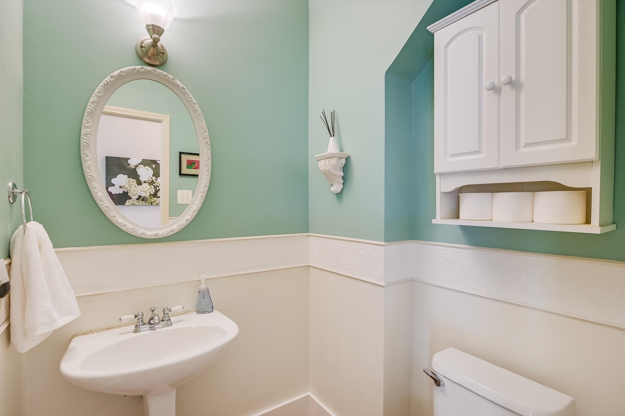 6456 Ruxton Lane Austin, TX 78749 - Photo 23 of 30 A compact, well-appointed half-bath featuring a stylish pedestal sink and ample wall storage.