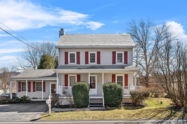 a front view of house with yard space and parking