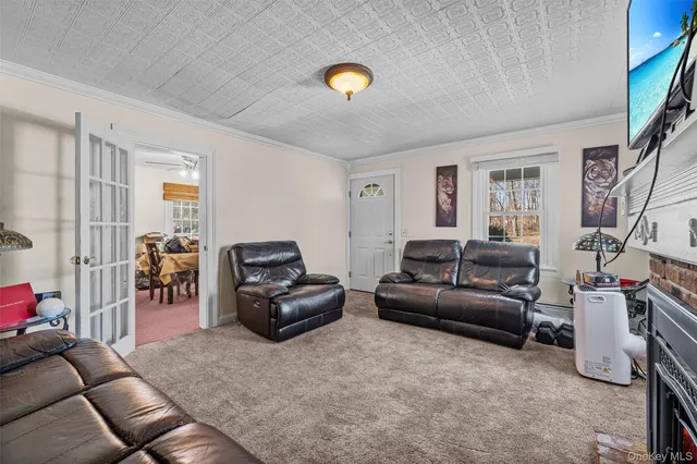 a living room with furniture and a lamp