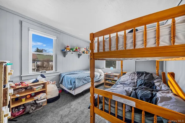 a bedroom with two beds and a window