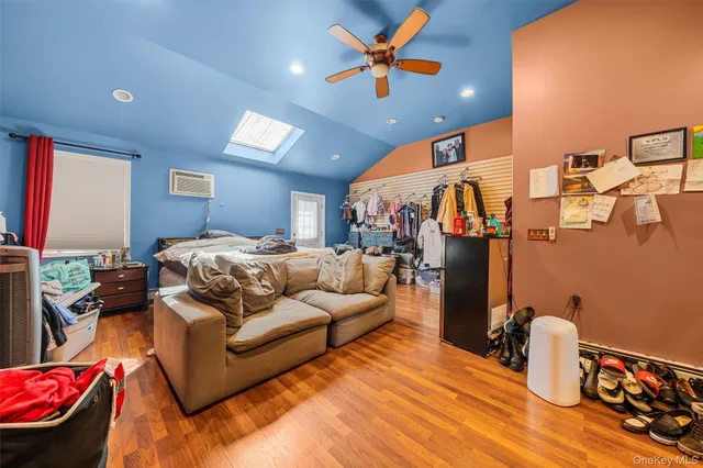 a bedroom with furniture and a flat screen tv
