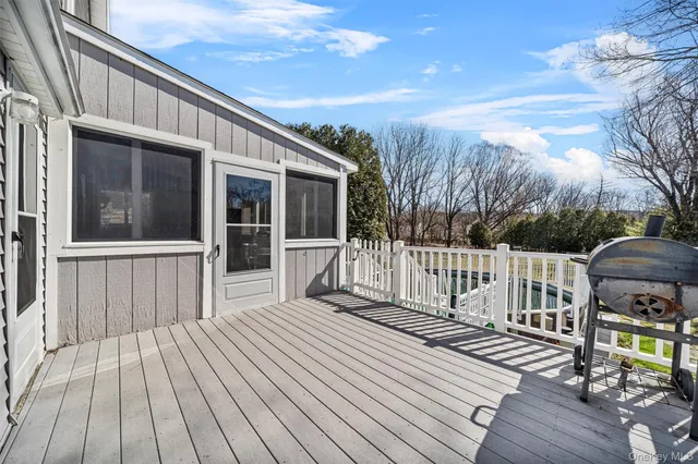 a view of a swimming pool with a patio and a yard