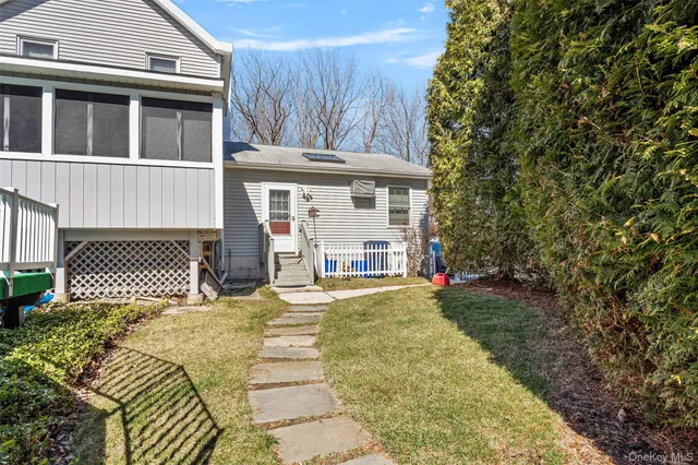 a front view of a house with yard and balcony