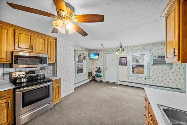 a view of kitchen with furniture and flat screen tv