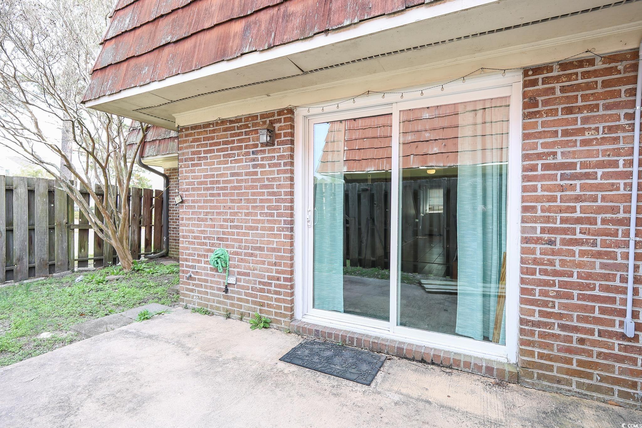 1025 Carolina Road, Unit O4 Conway, SC 29526 - Photo 21 of 22 Doorway to property featuring brick siding and fen