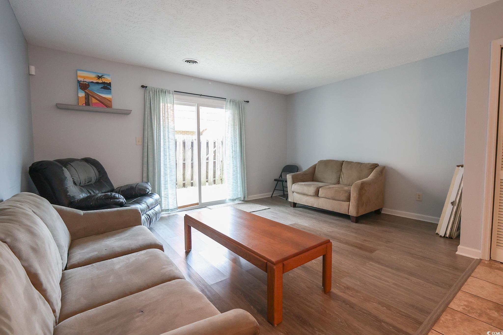 1025 Carolina Road, Unit O4 Conway, SC 29526 - Photo 3 of 22 Living area with baseboards, a textured ceiling, a