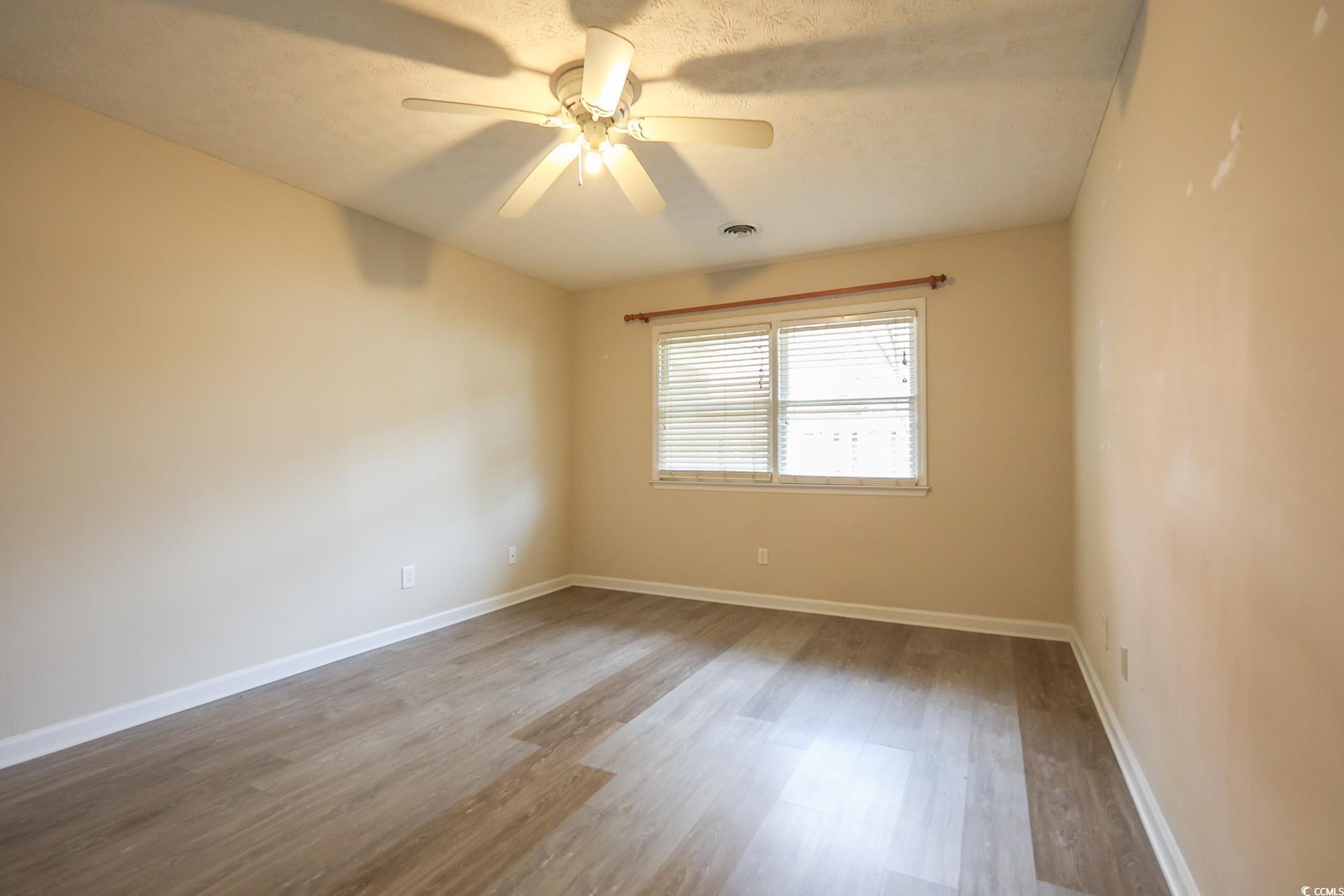 1025 Carolina Road, Unit O4 Conway, SC 29526 - Photo 7 of 22 Empty room featuring visible vents, ceiling fan, b