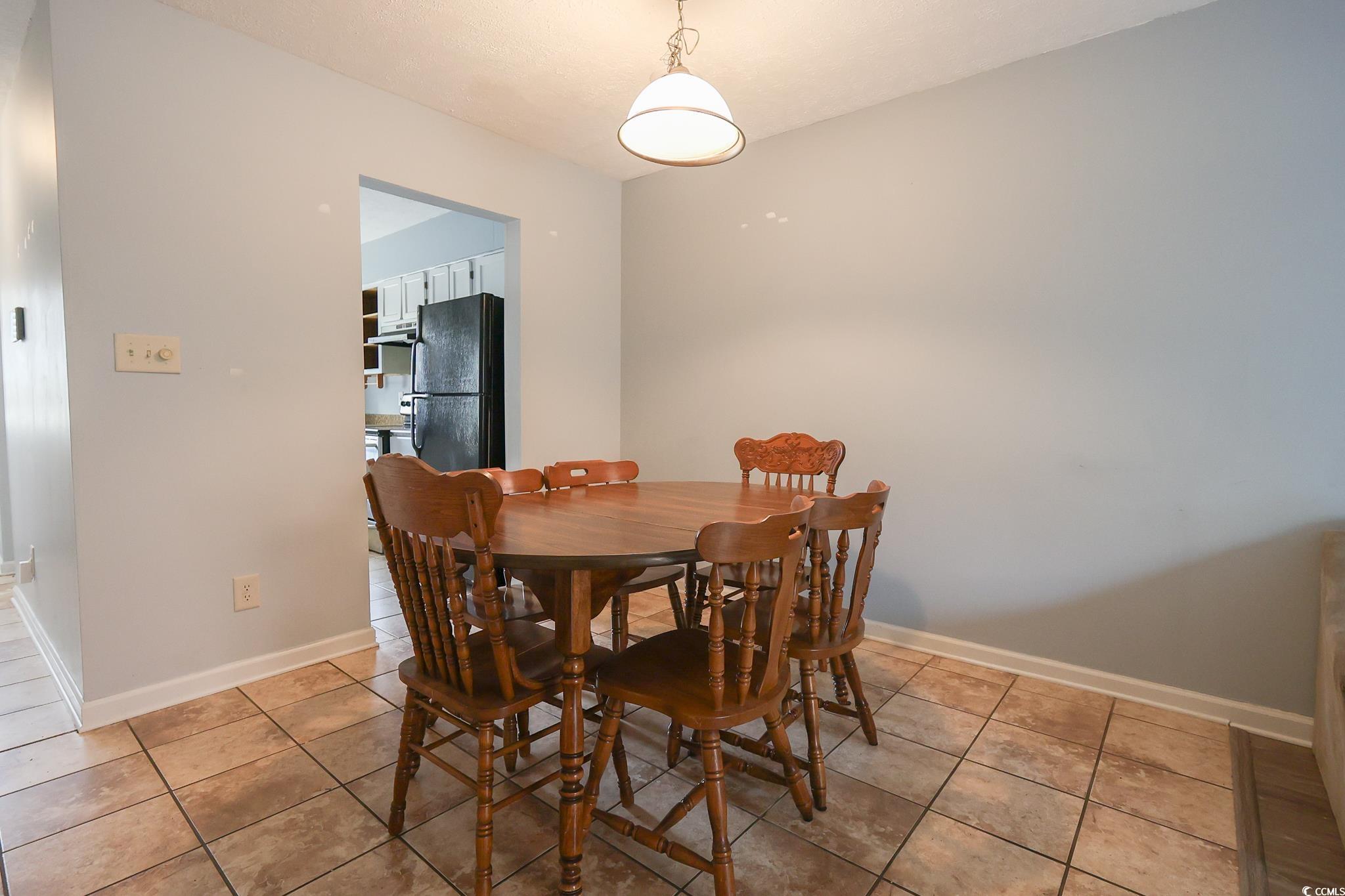 1025 Carolina Road, Unit O4 Conway, SC 29526 - Photo 10 of 22 Dining area with light tile patterned floors and b