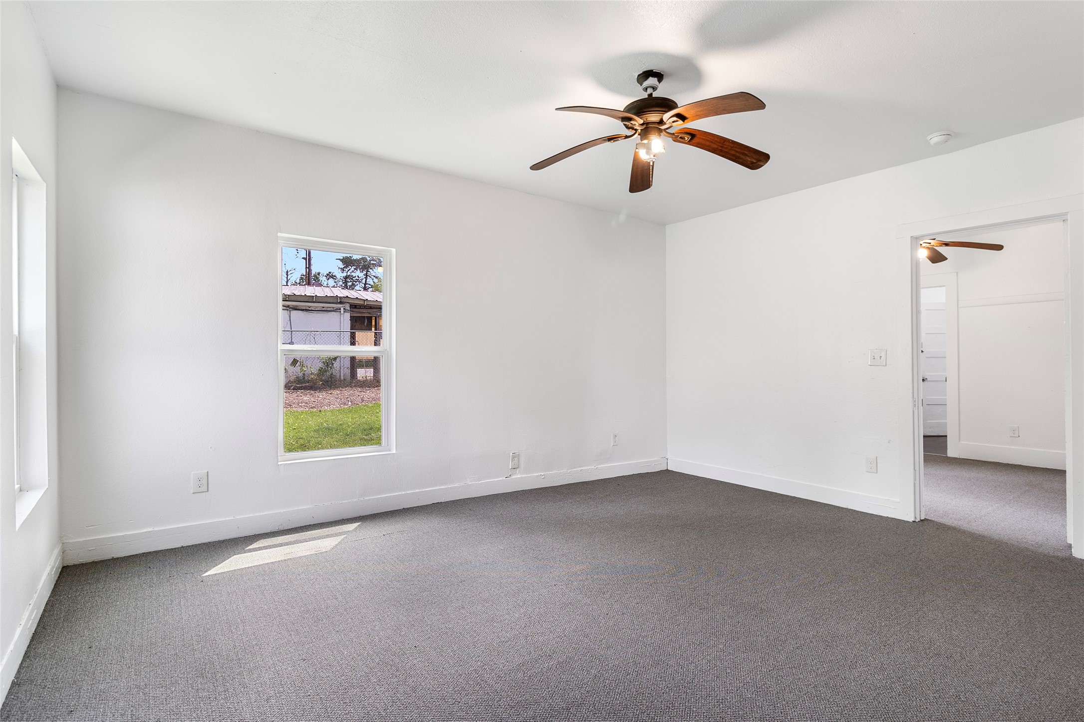 725 South Washington Avenue Livingston, TX 77351 - Photo 8 of 17 wooden floor in an empty room with a window