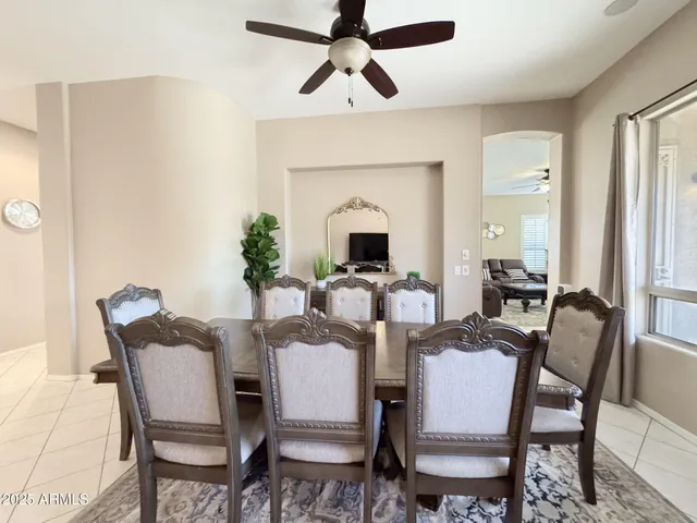 a view of a dining room with furniture and a chandelier