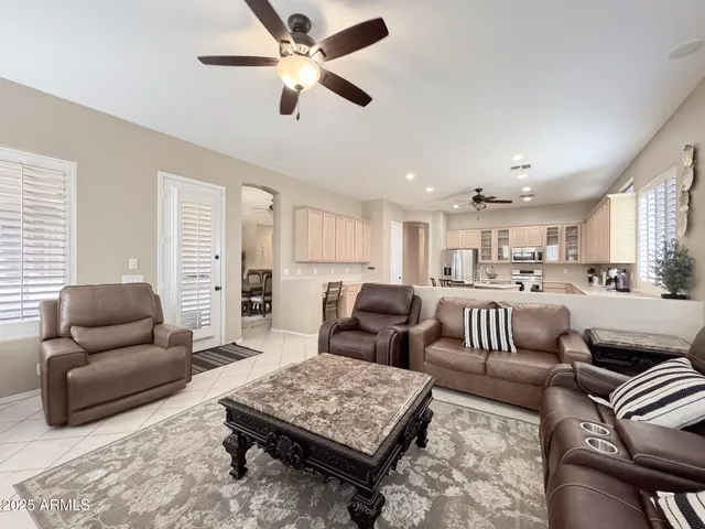 a living room with furniture ceiling fan and a rug