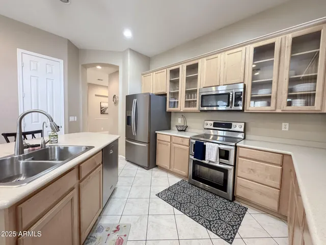 a kitchen with stainless steel appliances granite countertop a refrigerator and a sink