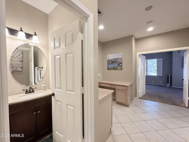a en suite bathroom with a double vanity sink and a mirror