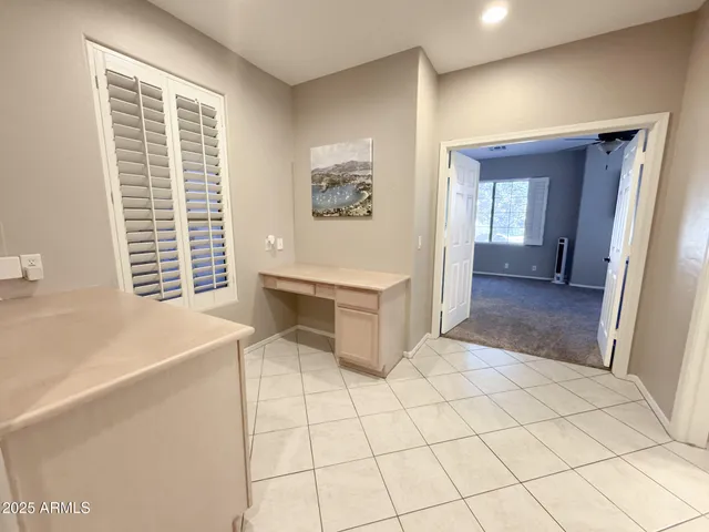 a view of an empty room with window and cabinet