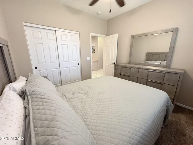 a bedroom with a bed and a mirror